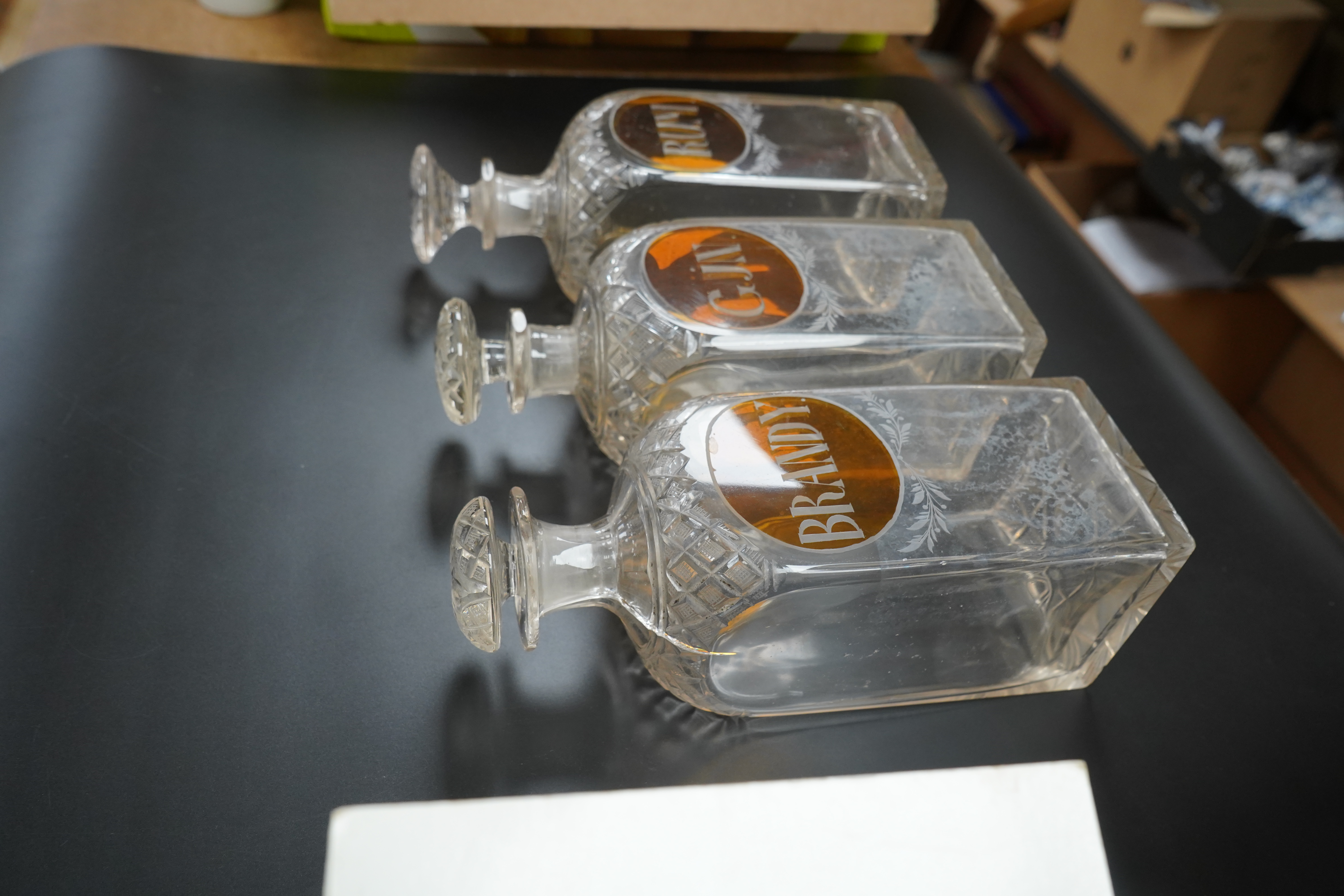 Three 19th century cut glass decanters for 'Rum' 'Gin' and 'Brandy', 23cm high